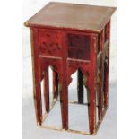 An early 20thC Japanese red lacquered stand, the square top with a shaped mother of pearl style inla