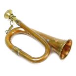 A miniature brass bugle, 15cm wide.