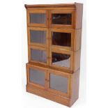 An early 20thC walnut Minty style stacking bookcase, with glazed doors and plinth, 152cm high, 88cm