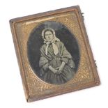 A late 19thC daguerreotype photograph miniature, depicting a lady, in a gold coloured frame, in a br