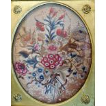 A George III needlework floral panel, 37cm x 30cm oval, (AF), gilt framed.