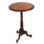 An early Victorian walnut wine table, the circular moulded top over a twist stem, on a tripod base,