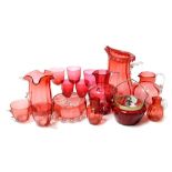 A group of late 19th/early 20thC cranberry glass, to include a large Victorian glass flared stem jug