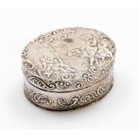 A Continental snuff box, of oval design with embossed decoration of cherubs, leaves and scrolls, whi