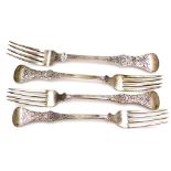 A group of four Eastern design forks, each with a bow and rose scroll handle, comprising two table f