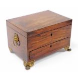 A Regency mahogany writing box, with dark and banded borders with lion mask handles, on rococo style