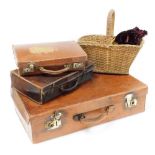 Three leather trunks and a wicker basket, the largest leather bound trunk with brass handle 66cm wid