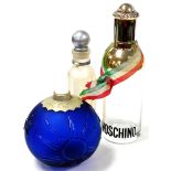 Three perfume advertising bottles, to include Moschino bottle, 39cm high, and a blue glass Moon and