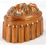 A Victorian oval copper jelly mould, with embossed decoration of roundels, fluted sides, unmarked, 1