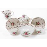 A group of Meissen ceramics, each of similar design with pink and purple flowers with delicate red s