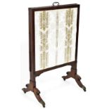 A 19thC mahogany articulated fire screen, with adjustable central section centred by a brass handle,