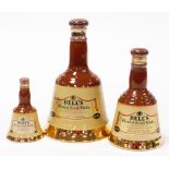 A group of three graduated Bells scotch whisky ceramic decanters, to include 37.5cl, 18.75cl and ano