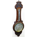 An oak cased mahogany wheel barometer, with a carved fleur de lis top, 82cm high.