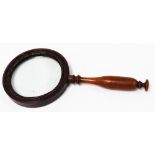A large early 19thC treen Library magnifying glass, overall length 32.5cm, lens diameter 12cm.