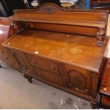 A carved oak sideboard, the shield shaped top with scroll applied decoration on baluster columns, ab