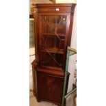 A flame mahogany finish corner cabinet, with astragal glazed door top and cupboard to base, 179cm hi