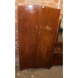 A mahogany finish bedroom suite, comprising two door wardrobe and a dressing table with large rectan