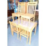 A pine tile top kitchen table and four matching chairs, 115cm wide, 75cm deep, 77cm high.