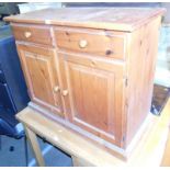 A pine dresser base, with two single drawers above two cupboard doors, on plinth base, 85cm high, 99