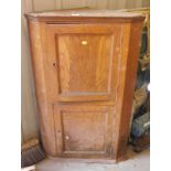 An early 19thC grain painted oak effect hanging corner cupboard.