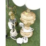 Four table lamps, comprising a brass corinthian column table lamp, a heavy gild decorated lamp, and