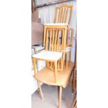 A melamine drop leaf kitchen table and set of four beech framed kitchen chairs.