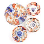 A Japanese Imari circular scalloped shaped charger, a similar later dish and two others. (4)