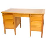 A mid 20thC oak desk, the top above two pedestals, each with drawers, 80cm high, 140cm wide, 73cm de