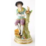 A Sitzendorf porcelain figure of a boy beside a bird's nest, 19cm high.