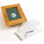 A golf glove signed by Colin Montgomerie, and a framed Callaway golf ball, the ball bearing signatur