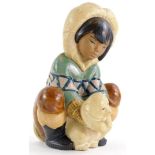 A Lladro porcelain figure of a child holding a polar bear, printed mark in blue to underside, 20cm h
