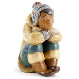 A Lladro porcelain figure of an Eskimo child, with head on hands, in seated position, printed mark i