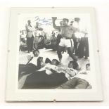 A black and white photograph bearing signature for Mohammed Ali, pictured with The Beatles, with a c