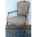 A 19thC French open armchair, with later floral upholstery.