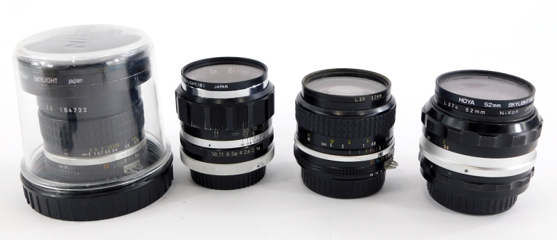 Four camera lenses to fit Nikon cameras, to include a Nikkor 18mm f3.5 super wide angle lens, a Nikk