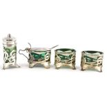 A silver mounted four piece Art Nouveau cruet set, with green glass liners.