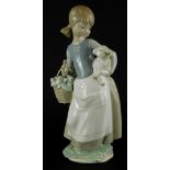A Lladro porcelain figure group, of a young girl with basket and a lamb, printed marks in blue to un