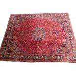 A large Persian Meshed type carpet, with a central medallion, surrounded by an elaborate design to t