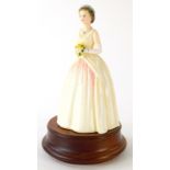 A Royal Doulton limited edition figure of Queen Elizabeth II, number 798/3500, on a wooden base, pri