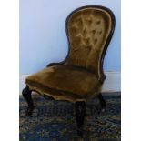 A Victorian mahogany spoonback nursing chair, with button back and square fore legs.