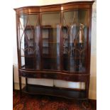 A late Victorian flamed mahogany display cabinet, with satinwood banded double bow front and serpent