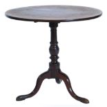 An early 19thC mahogany occasional table, with a circular top on a turned column and tripod base wit