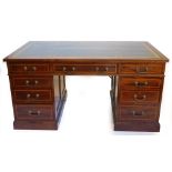 An Edwardian cross banded mahogany partner's desk, with green gilt leather top, with a traditional a