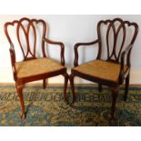 A pair of mahogany open armchairs, with pierced vase splat backs, hook arms and cabriole legs.
