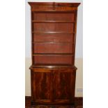 An early 19thC flamed mahogany open bookcase, on cabinet base, with moulded cornice and two panelled