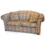 A Chesterfield sofa, with blue floral upholstery and loose cushions, 182cm wide, 93cm deep.
