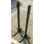 A pair of Spalding Multum-in-Parvo green painted patent cast iron tennis posts, 108cm high.