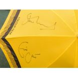 A Kodak golf umbrella, bearing signatures of Eric Clapton and Stevie Winwood.