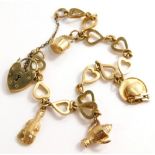 A charm bracelet, with various heart shaped links, each stamped 9c, with a heart shaped padlock and