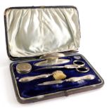 An Edwardian silver part travel or vanity case, of raised rectangular form, set with various impleme